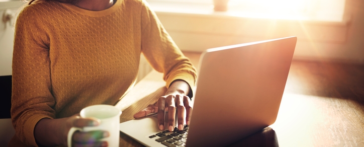 Woman Working on Computer with Coffee