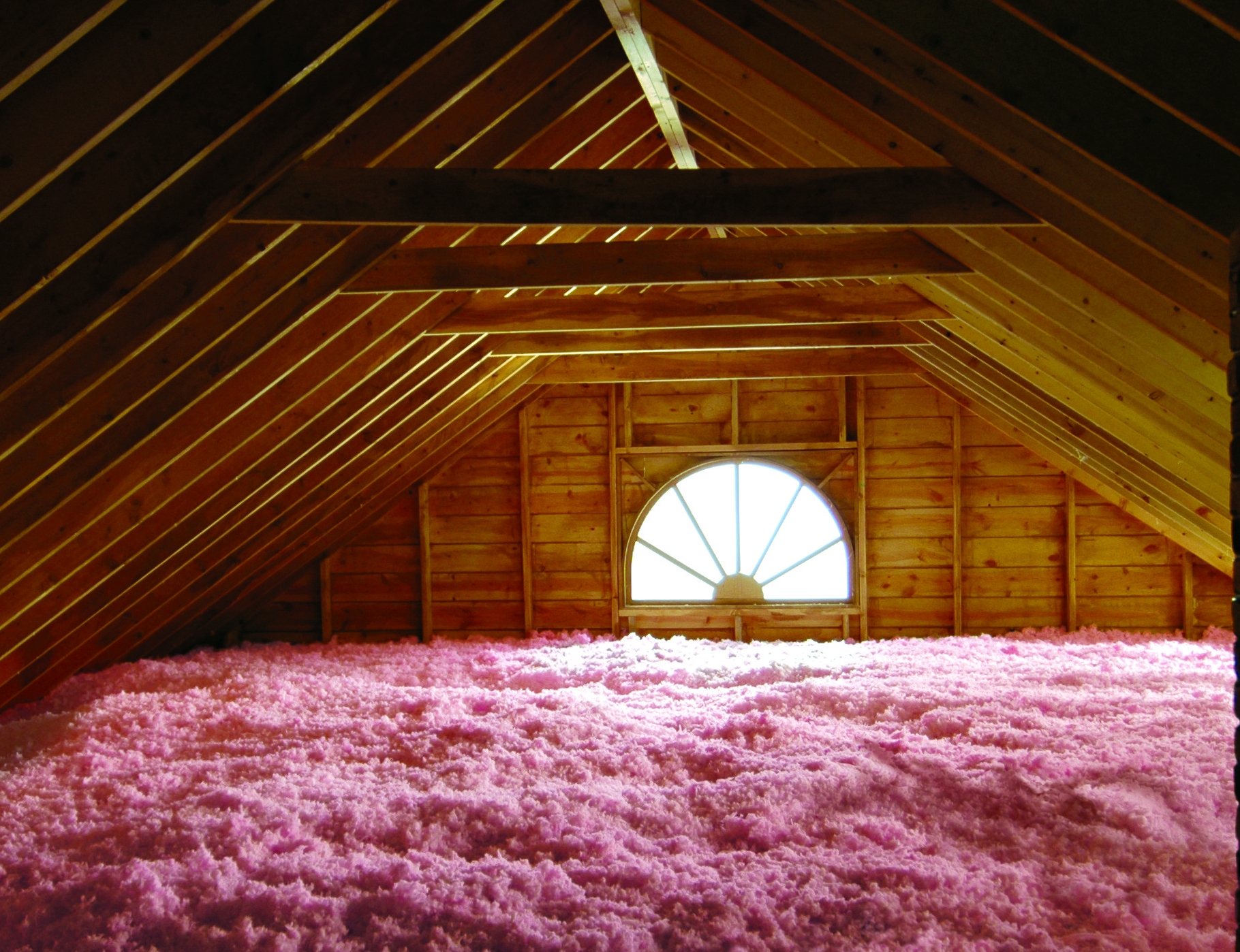 Professionally installed loose fill fiberglass insulation installed in the attic of Charlotte, NC home will vastly improve your year round comfort! Image of loose fill fiberglass insulation installed in an attic