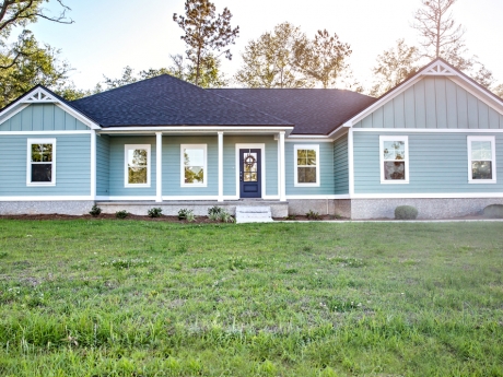 front view of a one story blue house