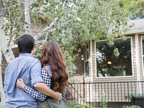 Couple Holding Each other in Front of New House