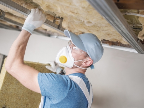 man installing attic insulation