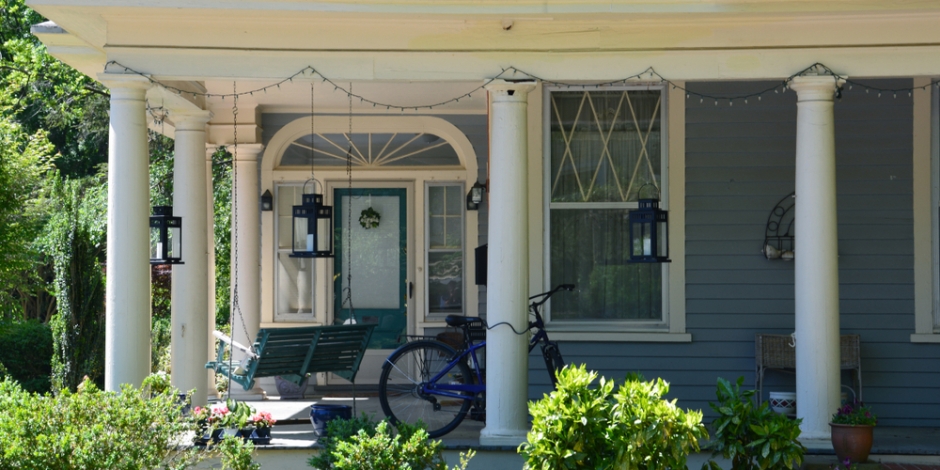 north carolina house blue with covered front porch and a bike