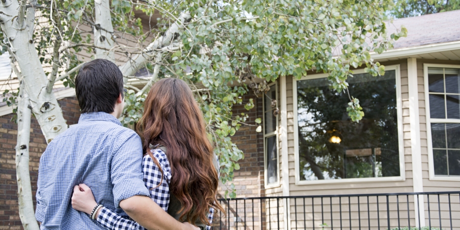 Couple Holding Each other in Front of New House